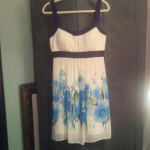 Cream dress with black outline and floral overlay